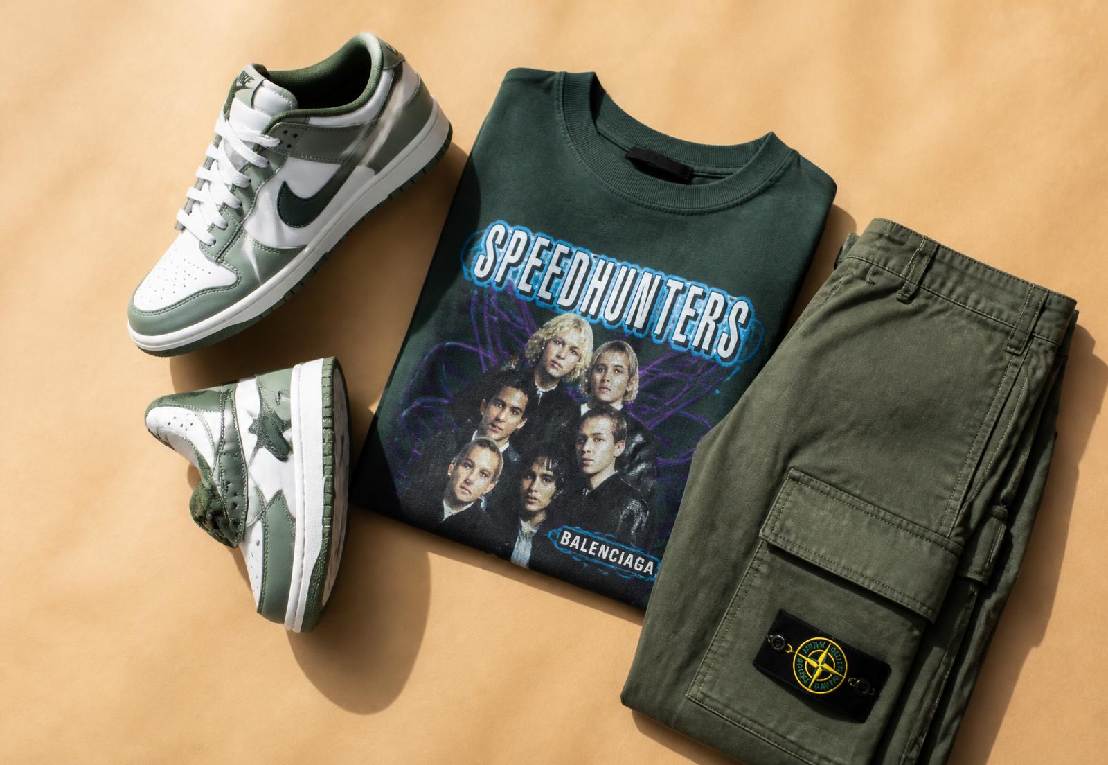 Sneakers, a folded graphic tee and cargo pants laid out for resale
